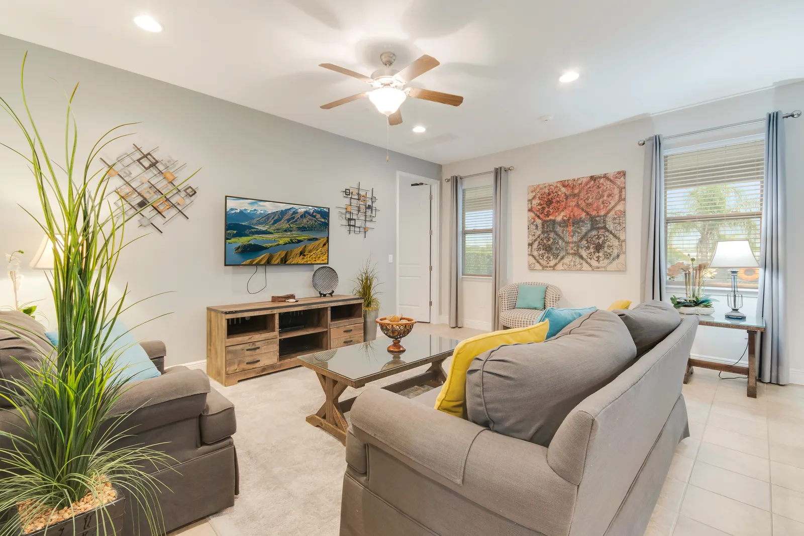 Bright open-plan great room with sectional sofa and TV