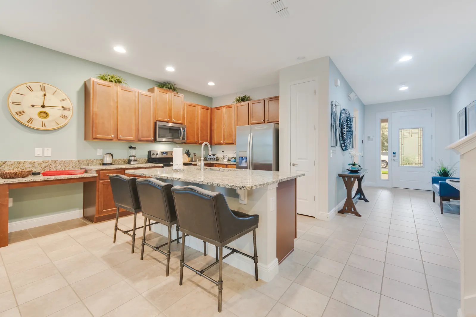 Kitchen with granite island, breakfast bar seating and ADA-height counter